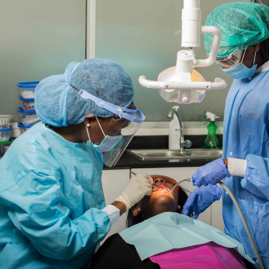 Dentist performing treatment on a patient at Taji Dental Clinic